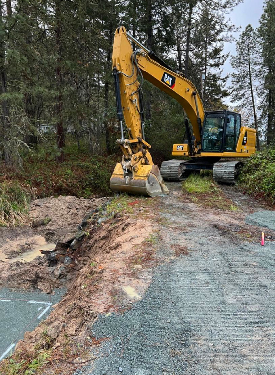 Grading a long gravel driveway to improve drainage and smooth the surface