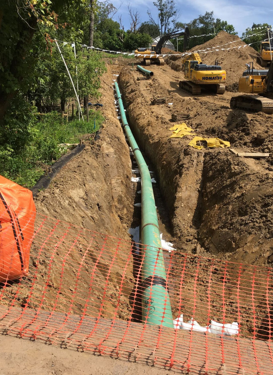 Trenching for underground electric and water line installation to a new home